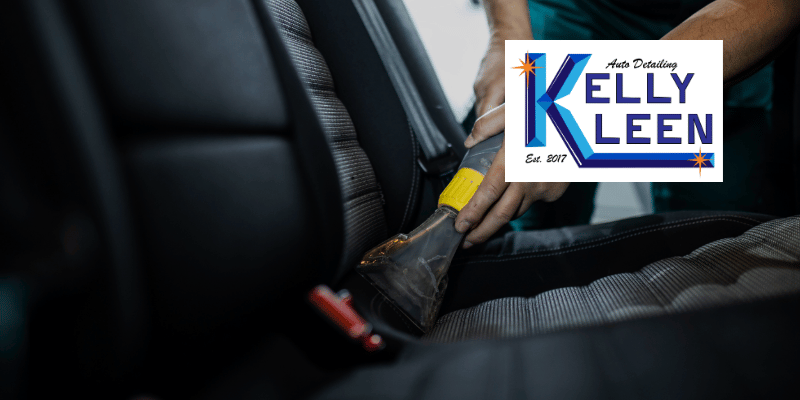 a person detailing their car with a shop vacuum